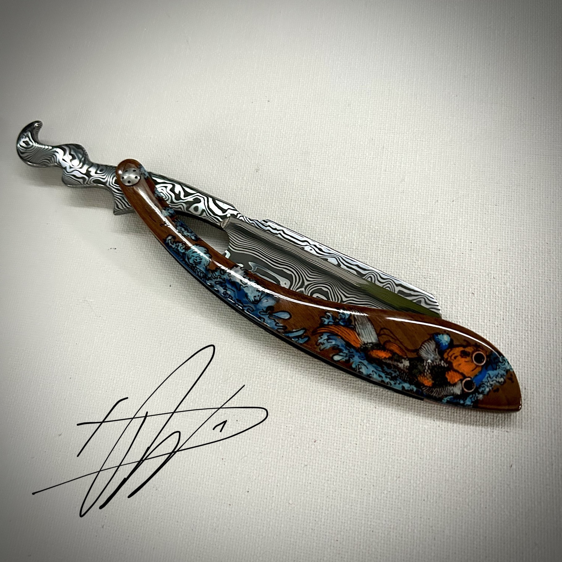 Woolfblades 348 Custom Made in a Vinland Damasteel razor ,And the scales are made in a solid wood with carbon fibre inlays the koi design is hand painted