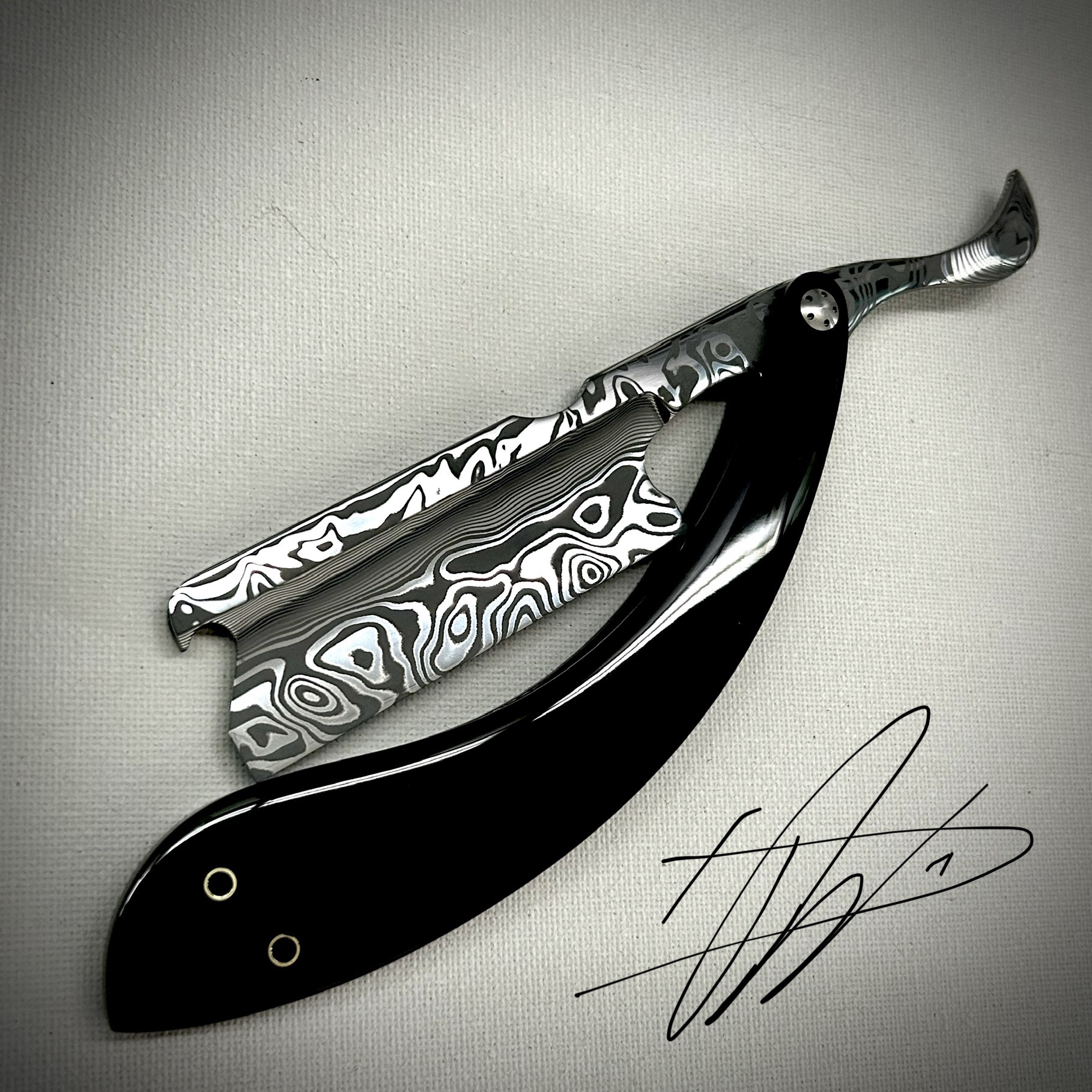 Woolfblades 356 Custom Made in a Vinland Damasteel razor ,And the scales are made in a tortious shell kerinite resin with carbon fibre inlays